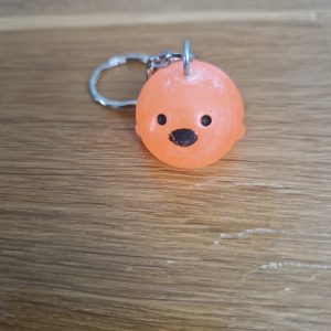R/Porte clés boule animaux poussin orange fluo (traits dessinés)