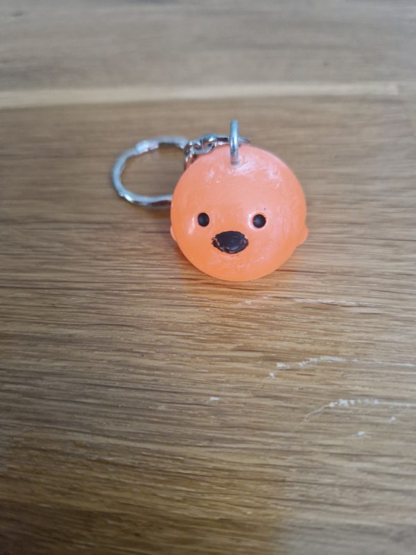 R/Porte clés boule animaux poussin orange fluo (traits dessinés)