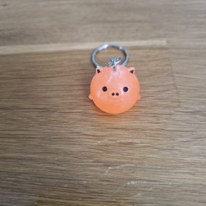 R/Porte clés boule animaux cochon orange fluo (traits dessinés)